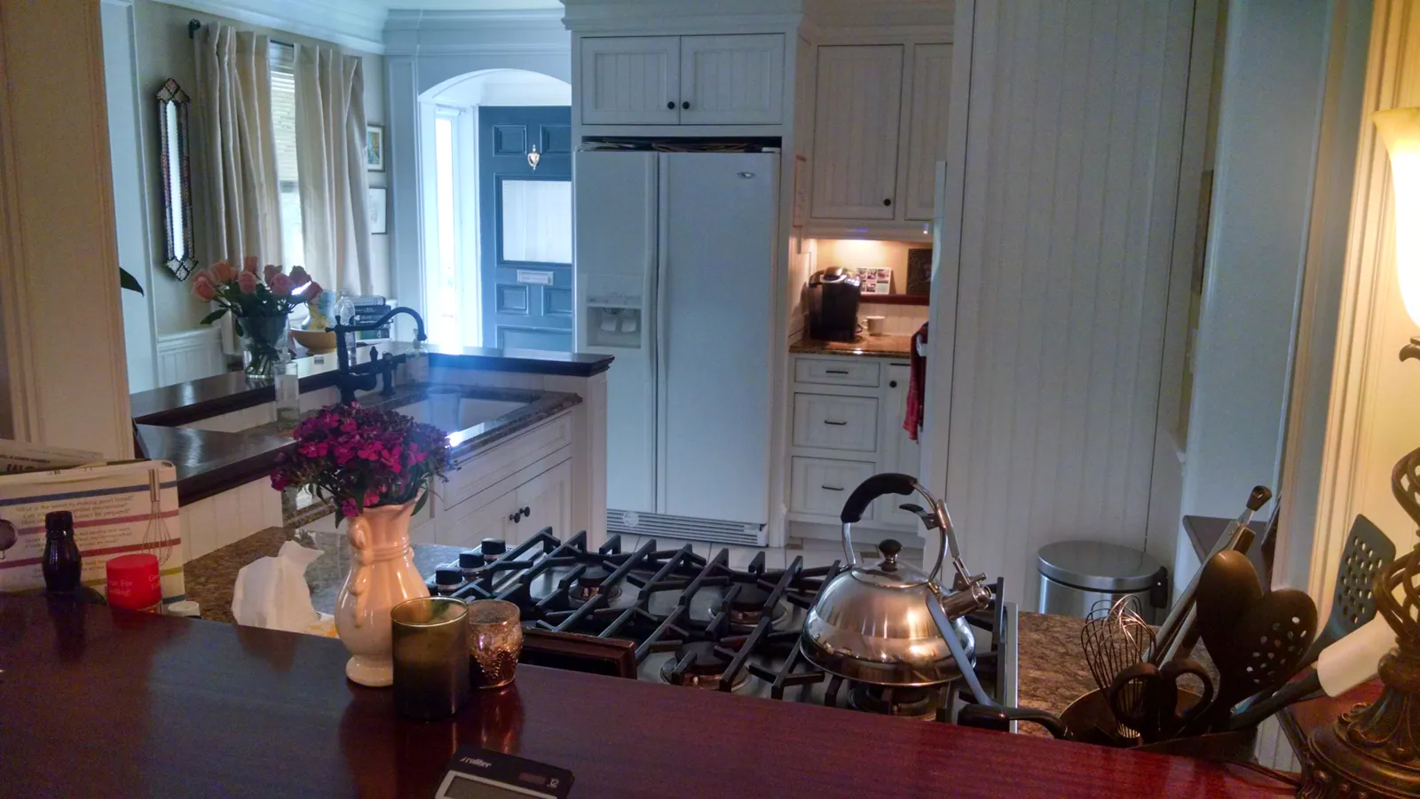 Kitchen with white painted cabinets and a red counter