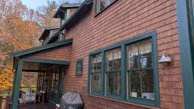 Cedar-shingle home with teal window trim
