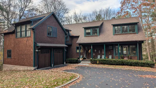Cedar-shingle house and barn with teal trim