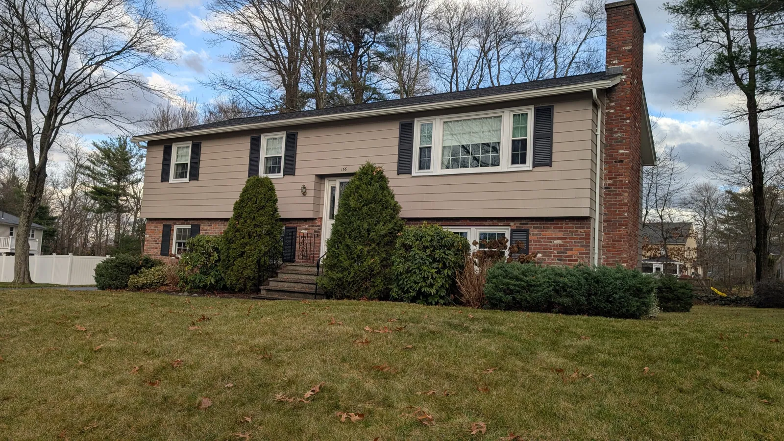 Tan raised ranch with a brick front
