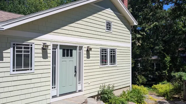 Sage cottage with a sea-green front door