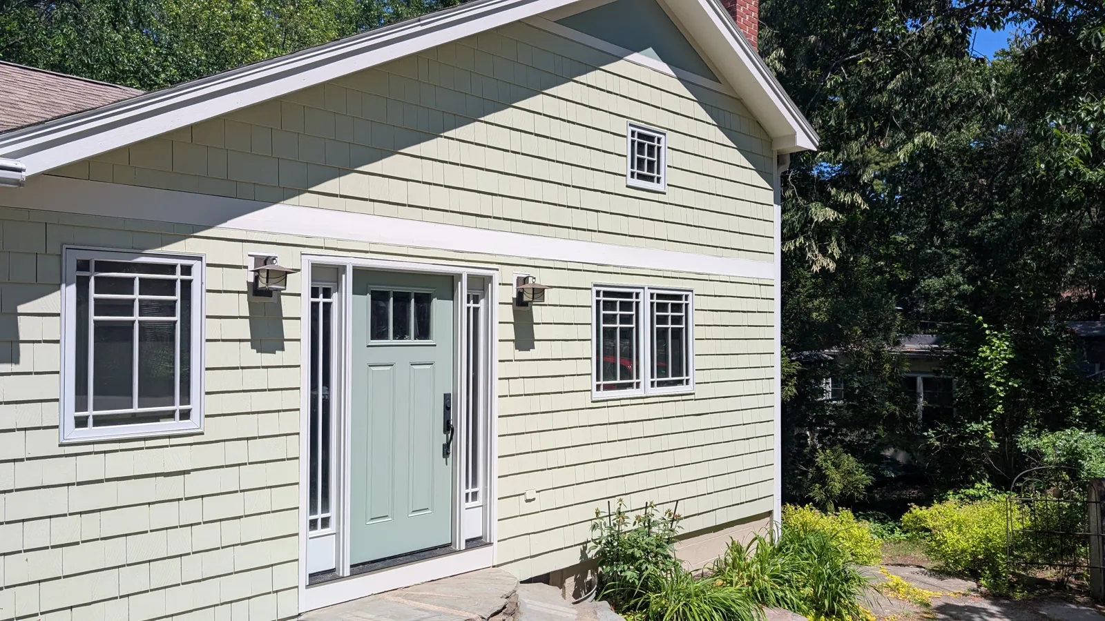Sage cottage with a sea-green front door