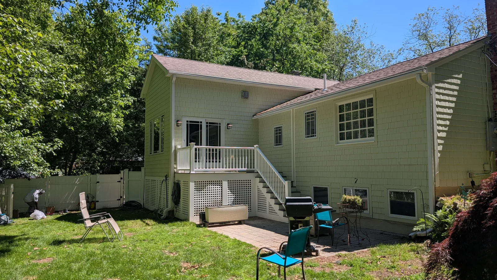 Sage home with a back deck and stairs