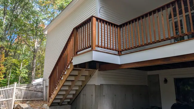 Stained deck stairs on a white house