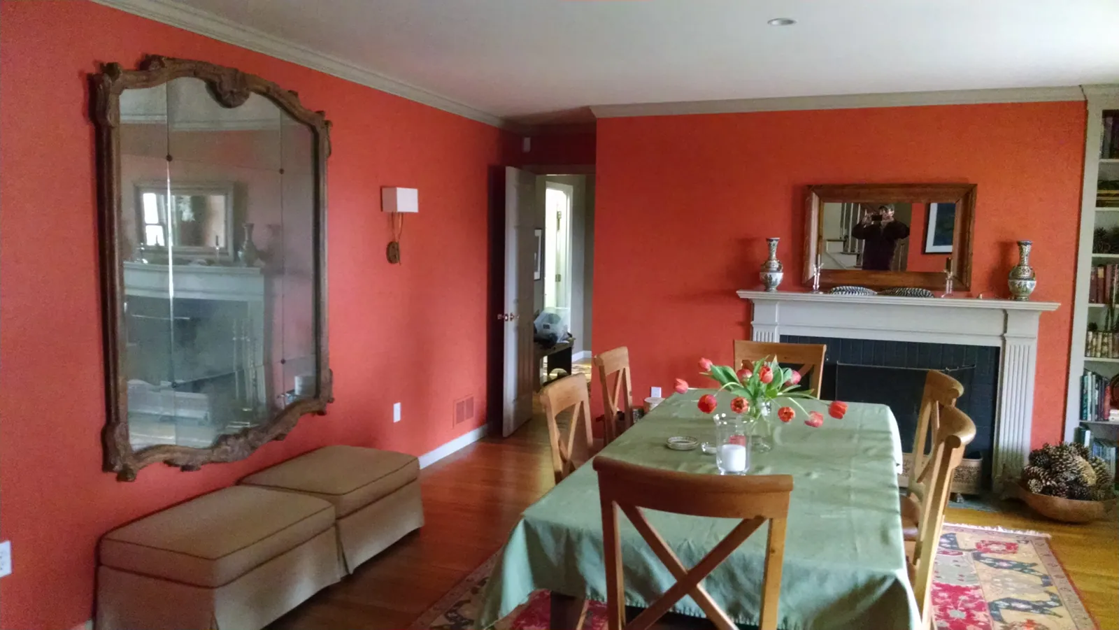 Dining room painted warm coral with white trim