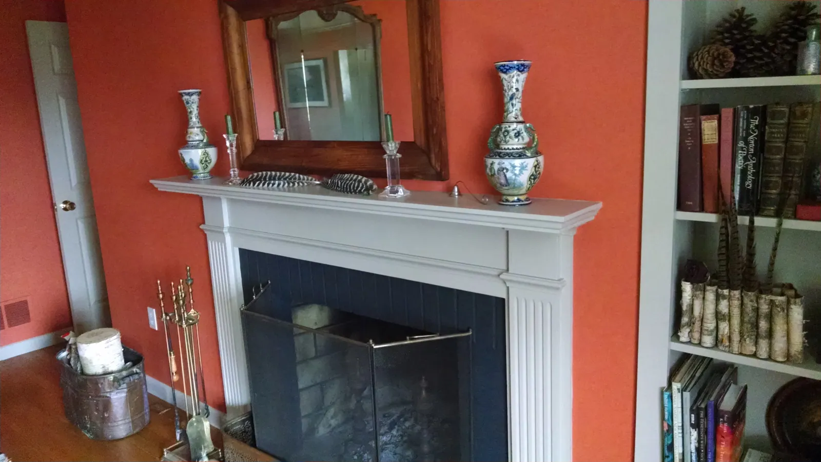 Coral room with a white-painted fireplace mantel