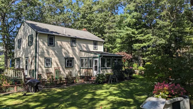 Sage colonial with a screened porch