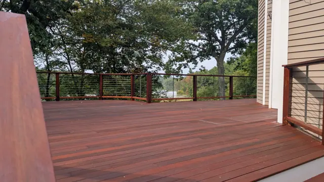 Freshly stained hardwood deck with cable railing