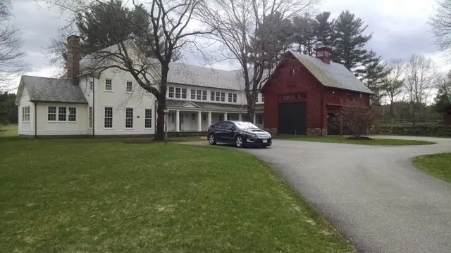 White farmhouse with a red barn