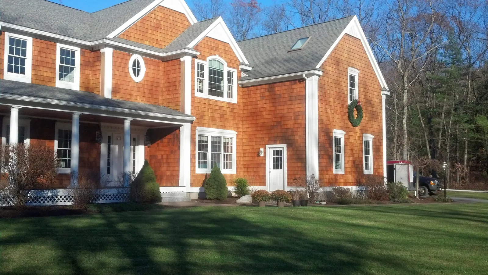 Cedar-shingle colonial with white trim and a wreath