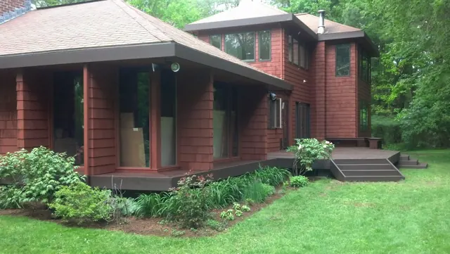 Contemporary home in red-stained cedar with a new deck
