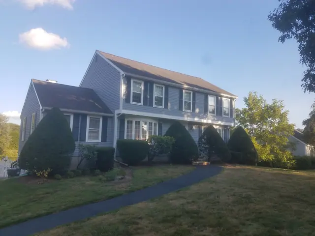 Blue-gray colonial with a long lawn