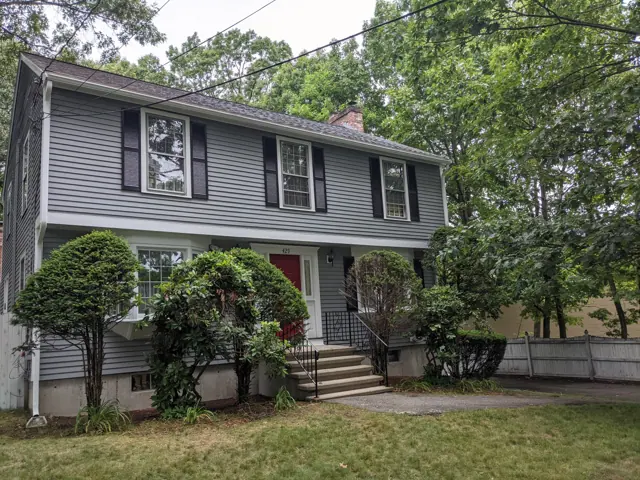 Gray colonial with a red front door