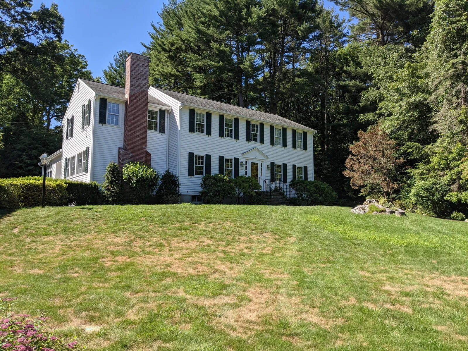 White colonial on a wide lawn
